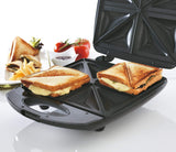 Triangular sandwich maker with two grilled sandwiches on a white background